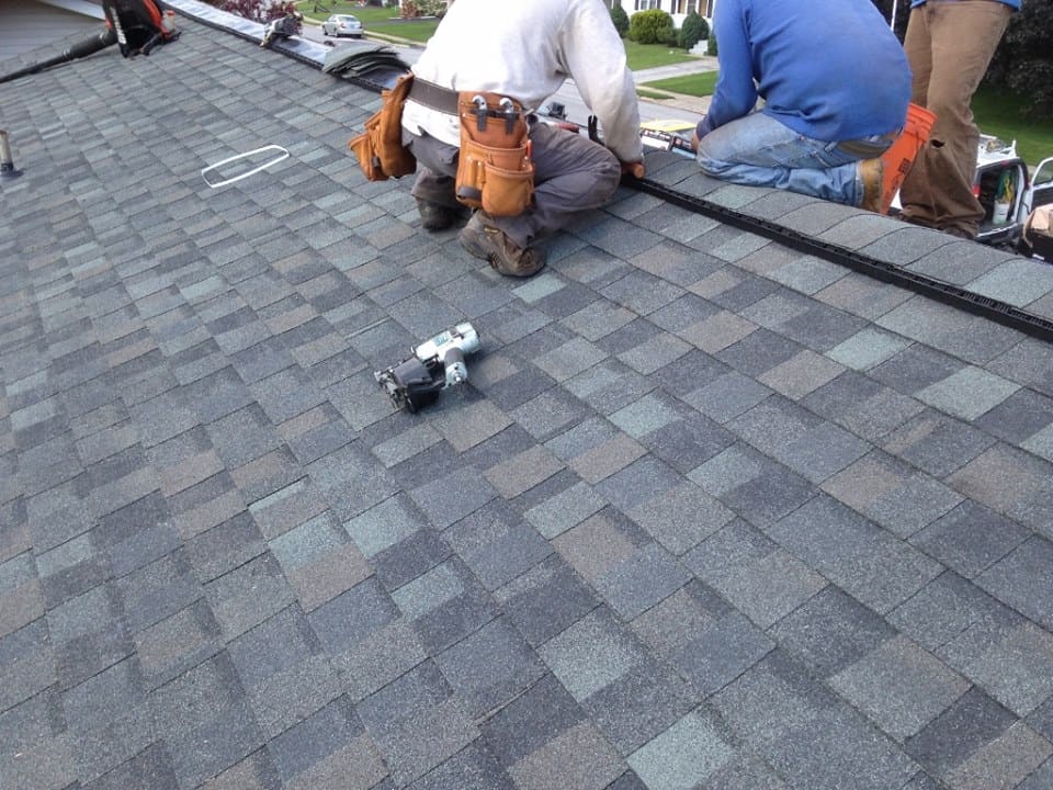 A roofer nails on the roof tiles in Owings Mills and Reisterstown, MD